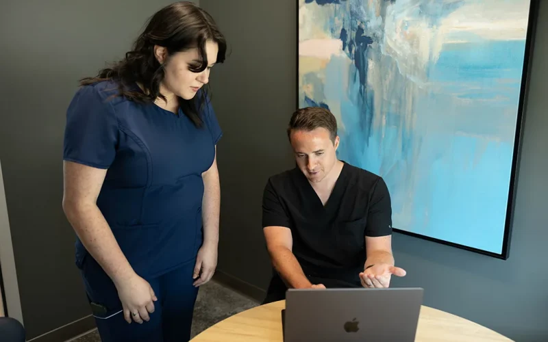 Modern Vision Centers team members reviewing EVO ICL pricing on a laptop